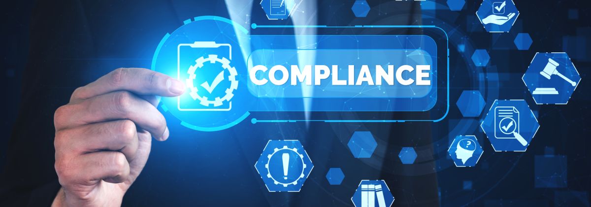 Businessman pointing at a digital compliance icon with law and policy symbols in the background.